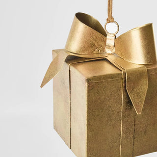 Gold gift box with a bow on a white background