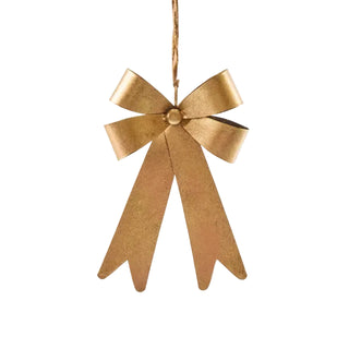 Gold bow-shaped ornament hanging against a white background