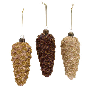 Three decorative pine cone ornaments with gold, brown, and bronze finishes on a white background.