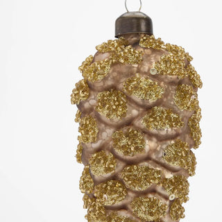 Decorative Christmas ornament resembling a pine cone with gold glitter on a white background