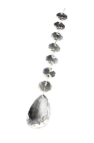 A teardrop-shaped crystal hanging ornament with a chain of smaller crystals attached to it, against a black background.