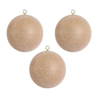 Three beige textured spherical ornaments with gold hooks on a light gray background