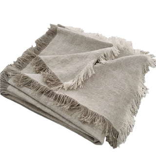 Beige blanket with fringes on a white background