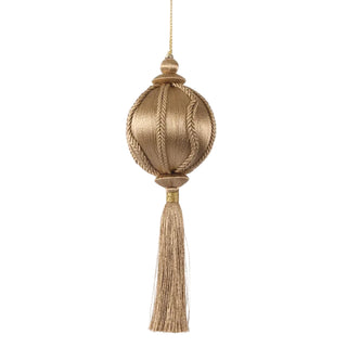 Decorative gold ornament with tassel on a white background