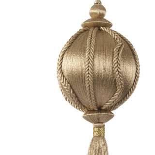Decorative gold tassel with braided design on a white background