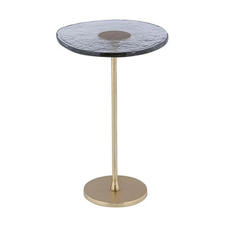 Small round table with a textured black top and gold base on a white background