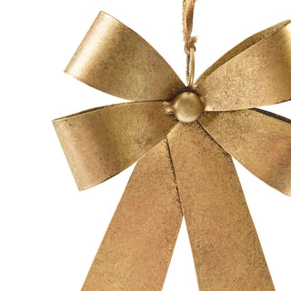 Gold bow-shaped ornament on a white background