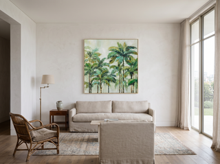 Cairns Nat framed canvas artwork hanging above an oatmeal linen sofa in an elegant Sydney living room — slim natural-tone frame, vintage rattan armchair, brass floor lamp