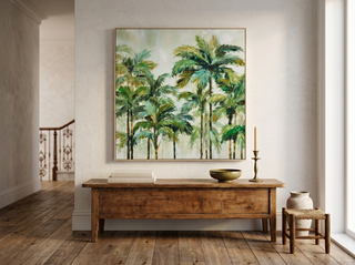 Cairns Nat tropical palm canvas artwork displayed above a vintage timber console in a refined Potts Point entry hall — brass candle holder, ceramic bowl, oak floors